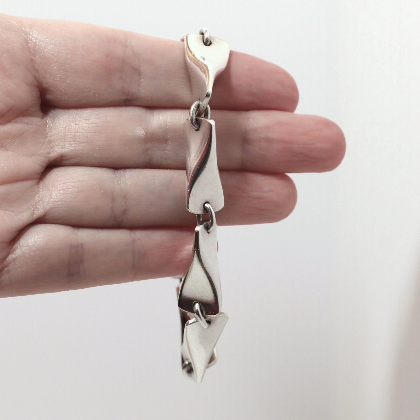 Georg Jensen vintage silver bracelet with sculptural links held in hand