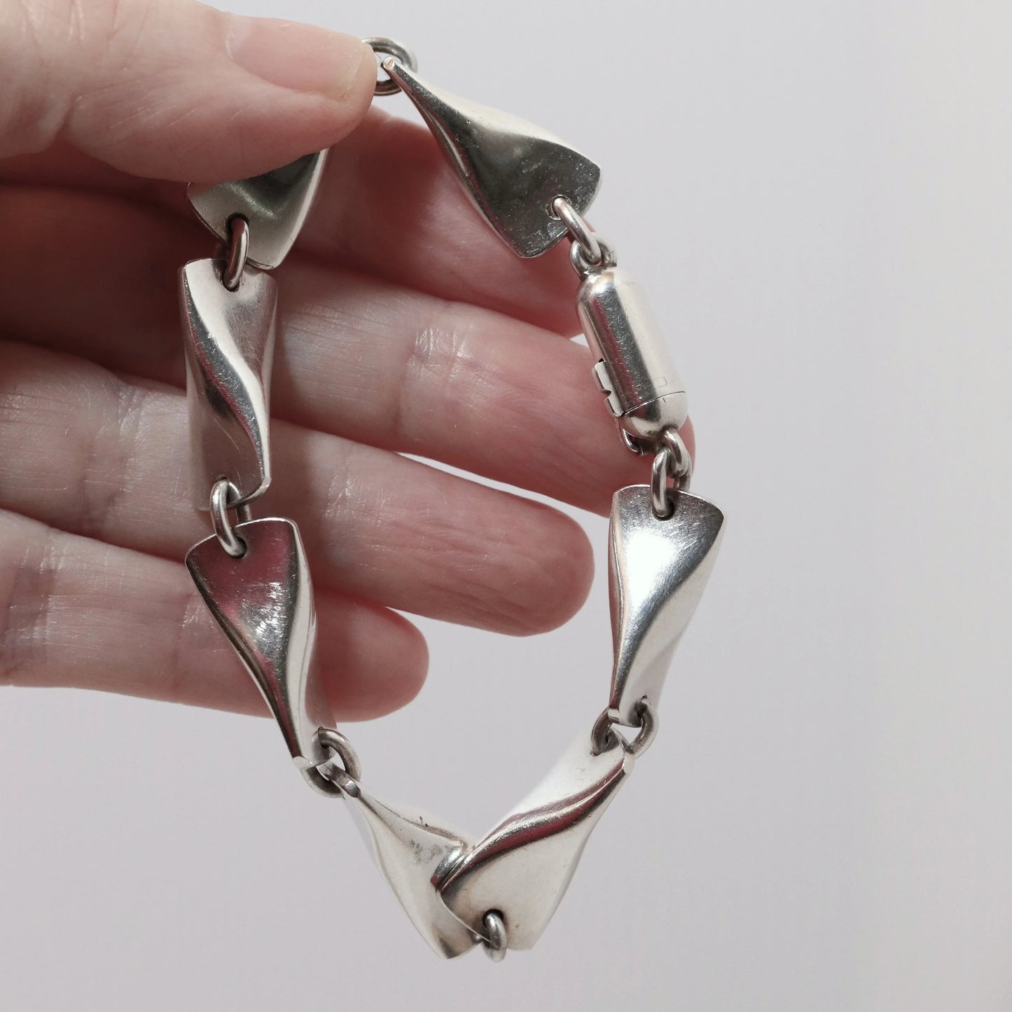Georg Jensen vintage silver bracelet with sculptural links, held in hand