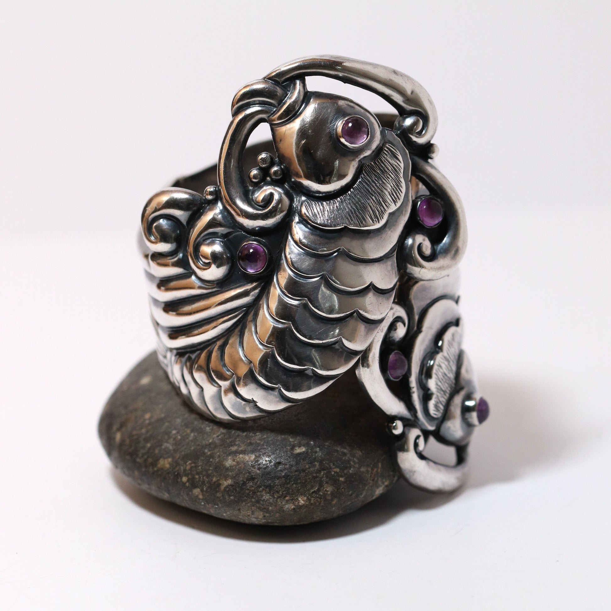 Margot de Taxco vintage silver koi bracelet with amethyst accents on a stone