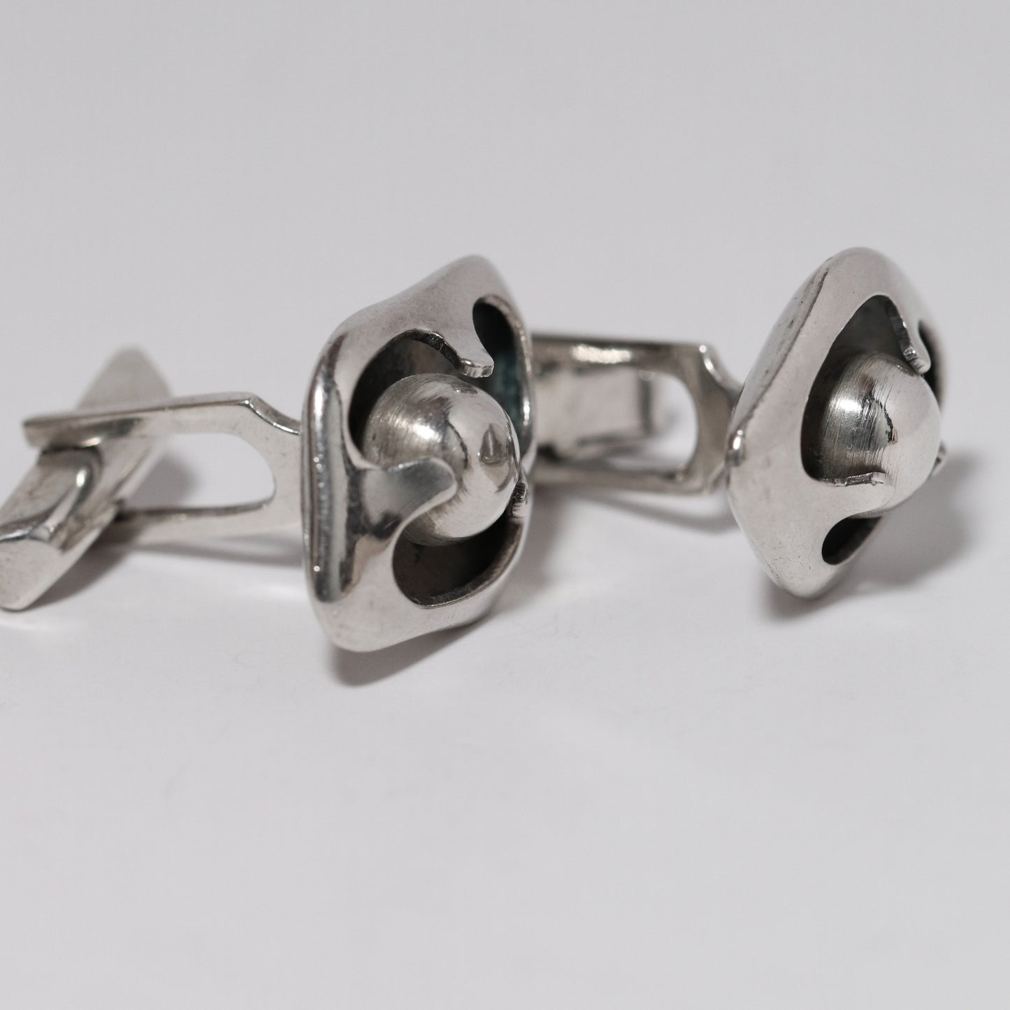 Sigi Pineda Taxco silver cufflinks with encased ball design, vintage jewelry close-up