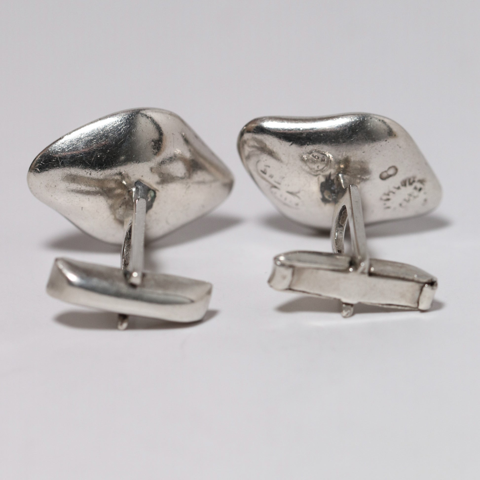 Sigi Pineda Taxco silver cufflinks with organic shape against a white background