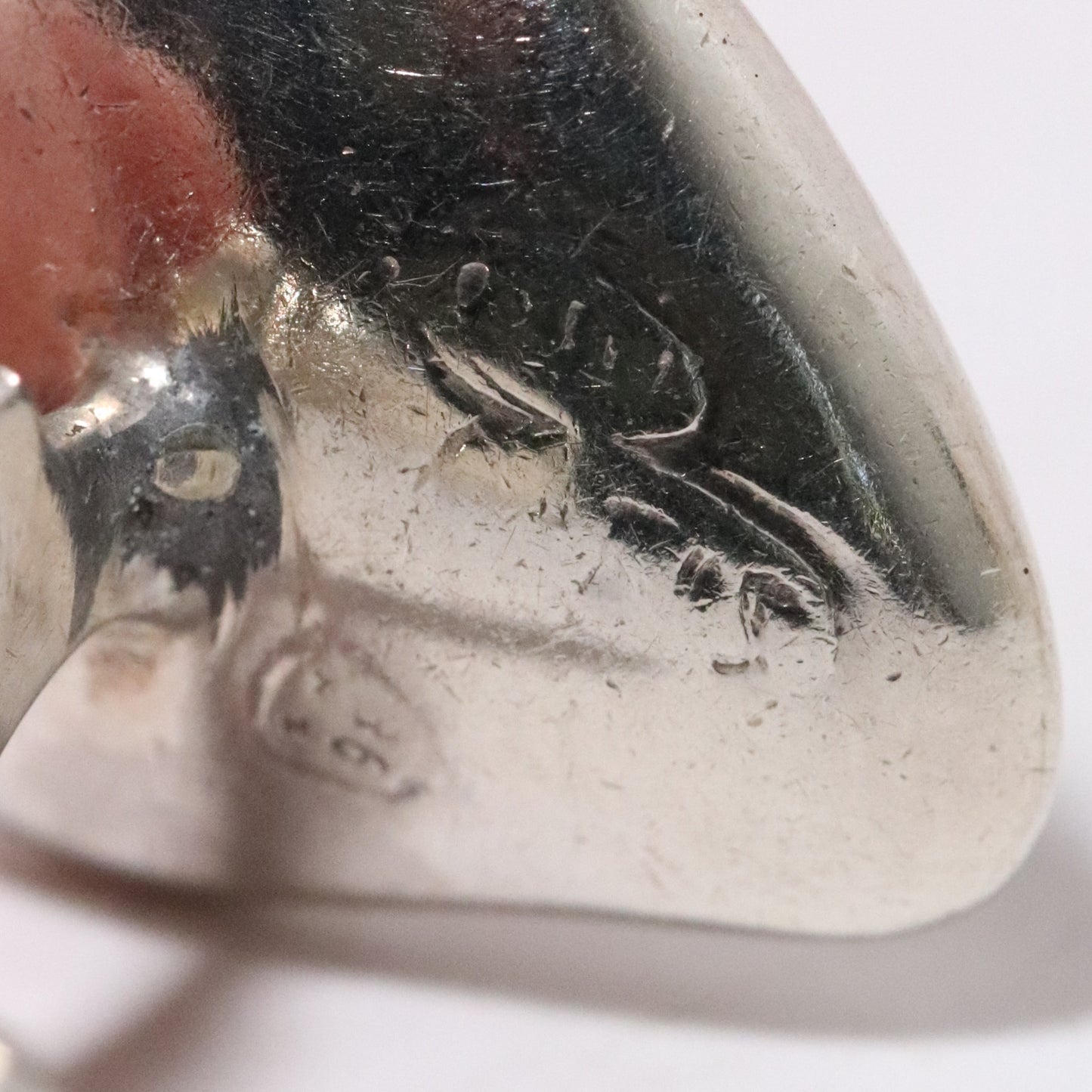 Close-up of Sigi Pineda Taxco silver cufflink with maker's mark and smooth finish