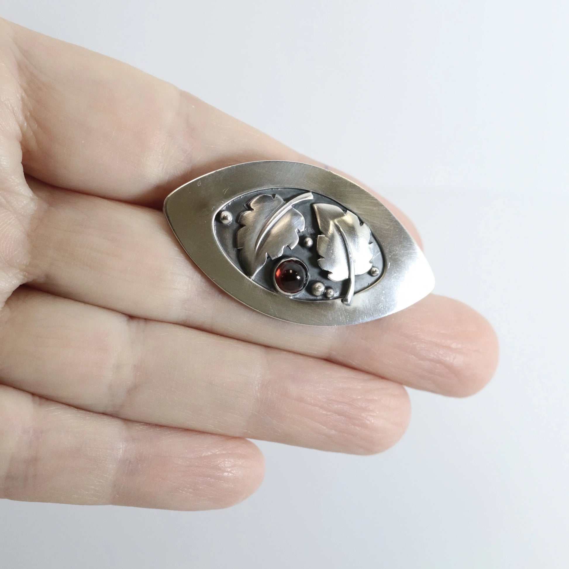 SOLD OUT: Vintage Lawrence Foss Silver Jewelry | Foliate and Garnet Brooch - Carmel Fine Silver Jewelry