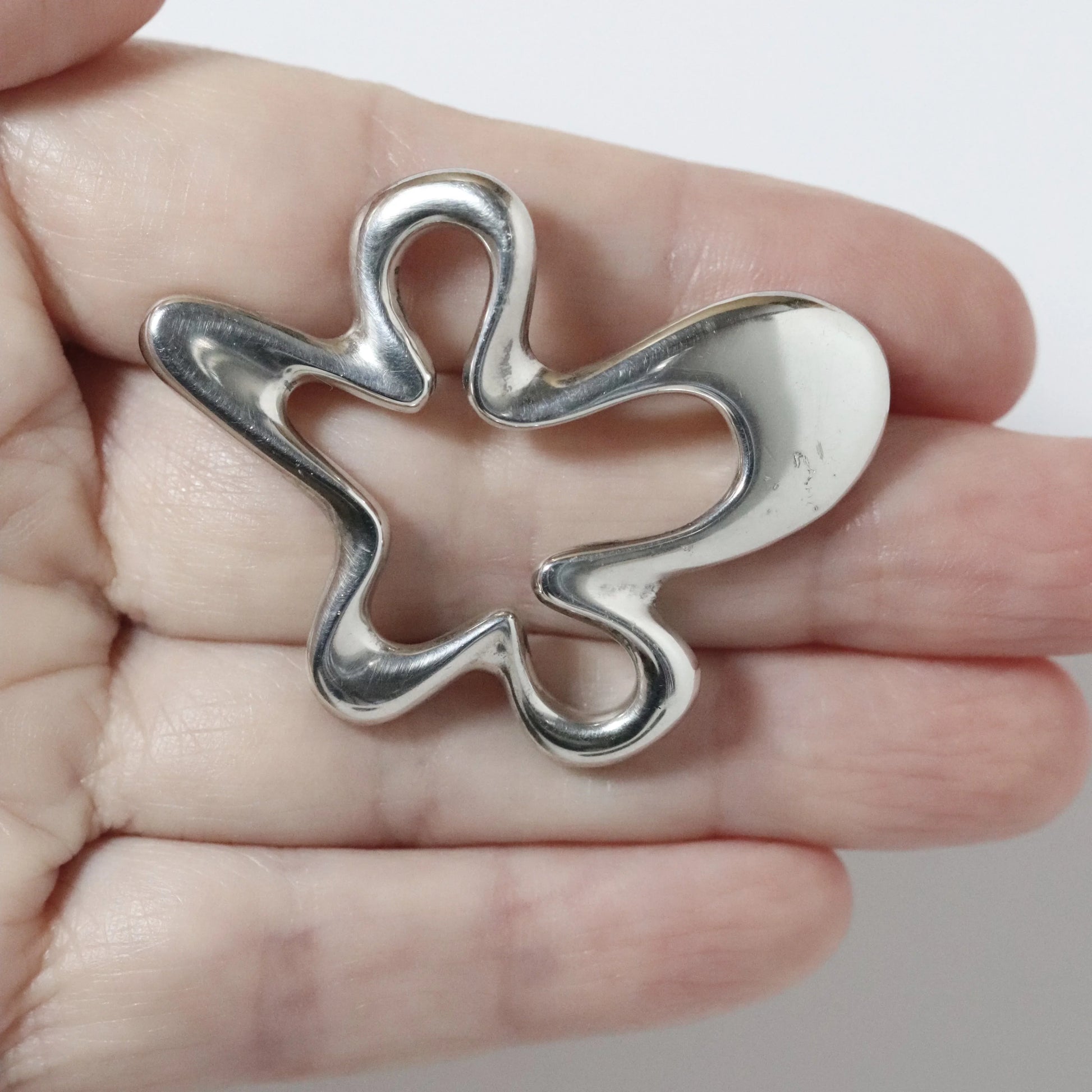Vintage Georg Jensen Henning Koppel abstract silver brooch held in hand