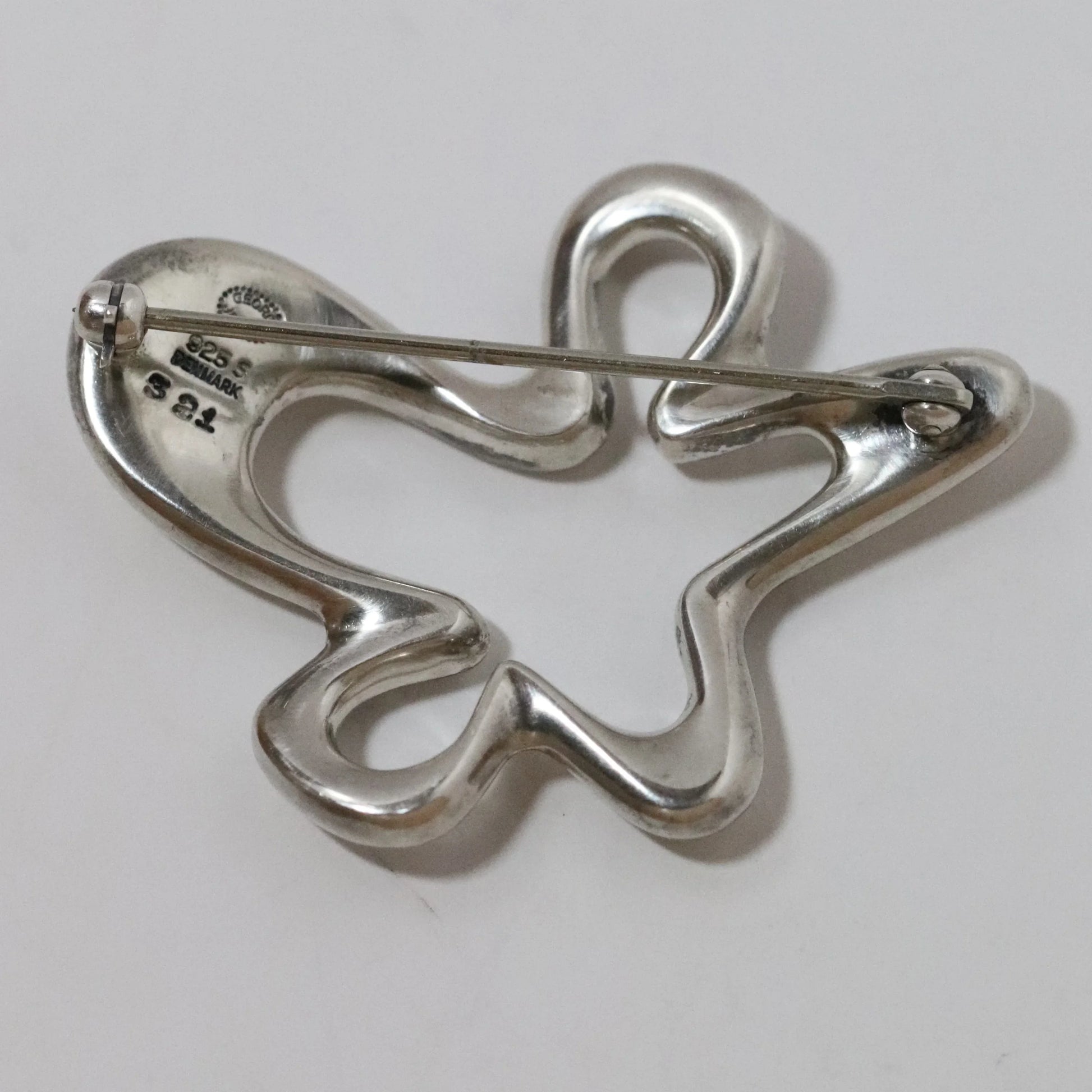 Vintage Georg Jensen Henning Koppel abstract sterling silver brooch on white background